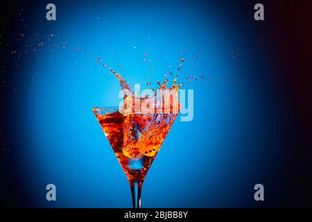 Martini in a fancy glass with blue game dice Stock Photo - Alamy