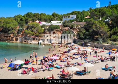SAN ANTONIO, SPAIN - JUNE 18: Sunbathers at Cala Gracio beach on June 18, 2015, in San Antonio, in Ibiza Island, Spain. Ibiza is a well-known summer t