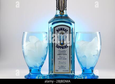 Bottle of Bombay Sapphire and goblets with ice with background Stock Photo