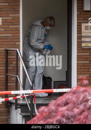 Gelsenkirchen, Germany. 29th Apr, 2020. Police investigators are securing evidence at a crime scene. A police officer was killed this morning during a SEK operation in Gelsenkirchen. When the officers were about to make a house search on a suspect in a drug investigation, he is said to have fired shots at the SEK officers. One of them hit the SEK policeman. Credit: Bernd Thissen/dpa - ATTENTION: Names on the bell plates were pixelated for legal reasons/dpa/Alamy Live News Stock Photo