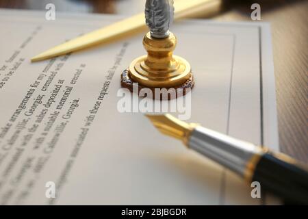 Stamping old notarial wax seal on document Stock Photo