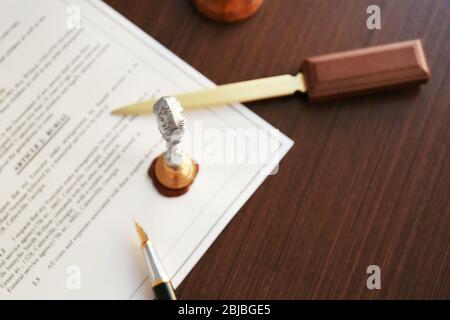 Stamping old notarial wax seal on document Stock Photo