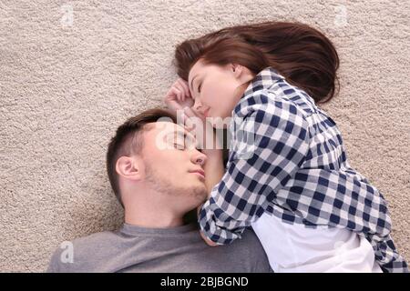 Happy couple hugging on floor Stock Photo