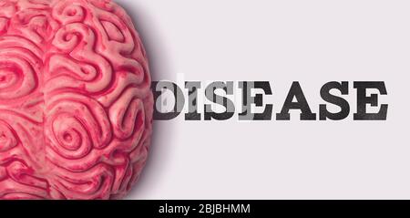 disease word next to a human brain model Stock Photo