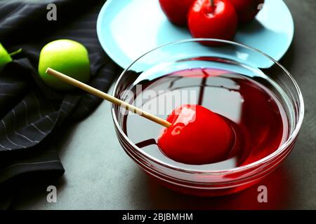 Caramel apple in bowl on table Stock Photo