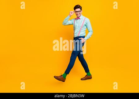 Full size profile photo of cool stylish guy boyfriend walk down street date girlfriend wear specs shirt bow tie suspenders trousers shoes isolated Stock Photo