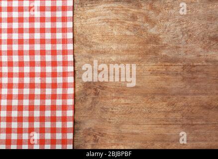 Red checkered tablecloth on wooden background Stock Photo