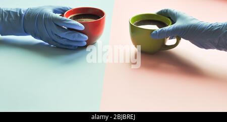 Americano in the different cups on the coral background. hand in a medical glove holds a cup Flat Lay, cheerful day concept. This image could be used Stock Photo