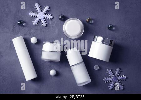 Beauty cosmetic products with Christmas decoration on gray background Stock Photo