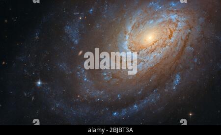 This remarkable spiral galaxy, known as NGC 4651, may look serene and peaceful as it swirls in the vast, silent emptiness of space, but don’t be foole Stock Photo