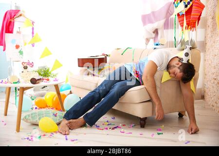 Tired drunk man after party at home Stock Photo