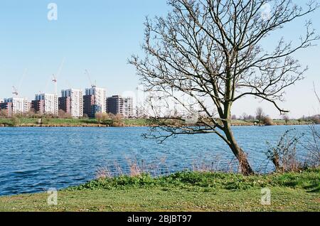 Low Maynard Reservoir in the Lee Valley, near Walthamstow, North London UK, with new apartment blocks under construction Stock Photo
