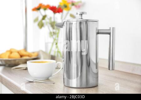 Coffee maker and breakfast with flowers on blurred background Stock Photo