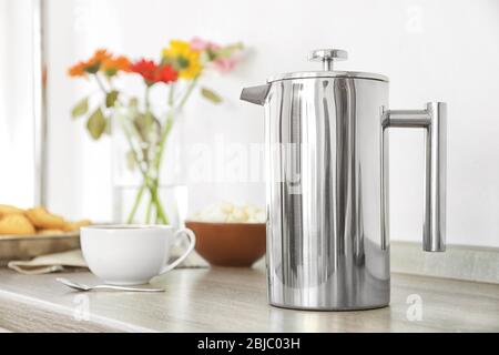 Coffee maker and breakfast with flowers on blurred background Stock Photo