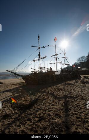 Town of Wallasey, England. Picturesque silhouetted view of the Black Pearl pirate ship on New Brighton beach. Stock Photo