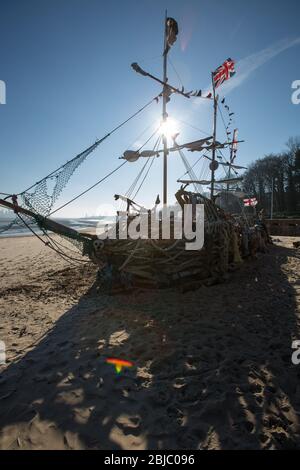 Town of Wallasey, England. Picturesque silhouetted view of the Black Pearl pirate ship on New Brighton beach. Stock Photo