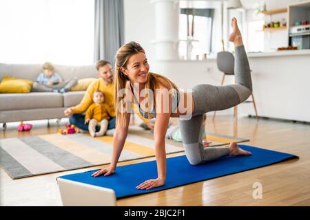 Sport yoga video streaming. Stay home. Home fitness workout class live streaming online. Stock Photo
