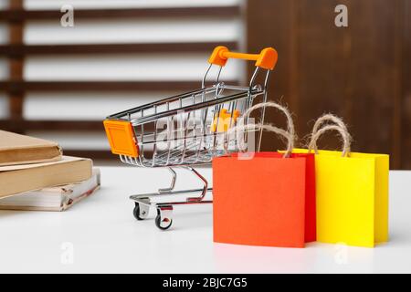 Download Small Shopping Cart With Paper Bags On Yellow Background Space For Text Stock Photo Alamy Yellowimages Mockups