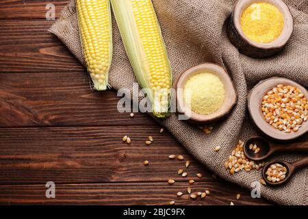 Corn seeds and groats on wooden table Stock Photo