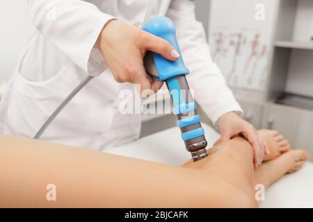 Extracorporeal Shockwave Therapy ESWT. Effective non-surgical treatment.Physical therapy of hamsting with shock waves. Pain relief, normalization and Stock Photo