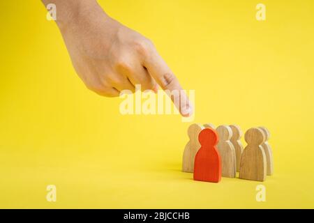 Group of wood figure hand pointing to the team leader in human resource management concepts Teamwork.Success Leadership, Business Progress and Competi Stock Photo
