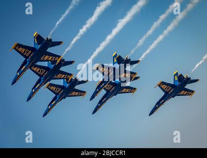 New York, United States. 28th Apr, 2020. The U.S. Navy Demonstration Squadron, the Blue Angels, top, fly across a clear blue sky during the America Strong flyover April 28, 2020 in New York City. America Strong is a salute from the Navy and Air Force to recognize healthcare workers, first responders, and other essential personnel in a show of national solidarity during the COVID-19 pandemic. Credit: Cory Bush/U.S. Air Force/Alamy Live News Stock Photo
