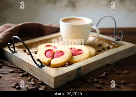 Heart shaped cookies with cup of coffee on tray, closeup Stock Photo