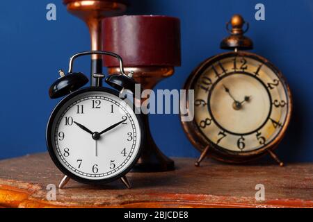Different alarm clocks on table. Time change concept Stock Photo