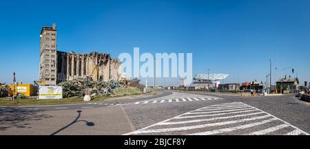 Demolition of the old grain warehouse in Antwerp, next to the modern Port House building. Stock Photo