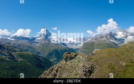 Young girl with open arms taking in the majestic Swiss Alpine scenery along the famous Five Lakes walking trail Stock Photo