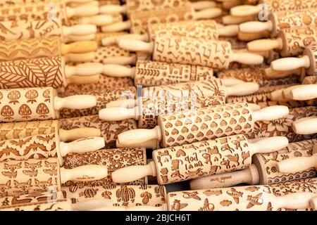 Wooden Corner brand decorated rolling pins with different symbol patterns on exposition. Unique handmade gifts, souvenirs, woodwork, arts and crafts Stock Photo