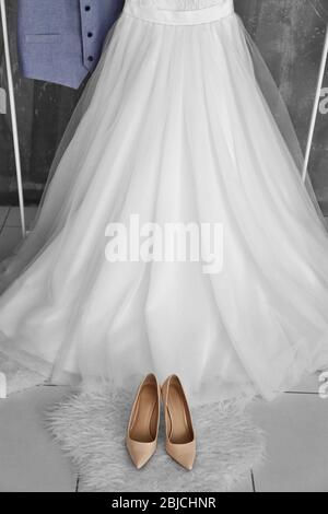 Bride dress with shoes and groom vest closeup Stock Photo