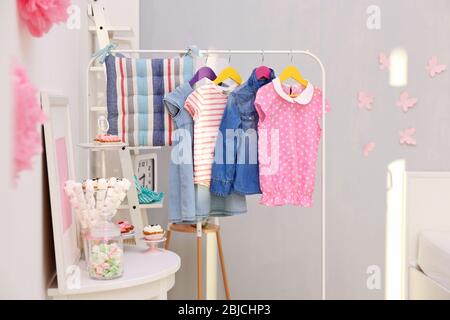 https://l450v.alamy.com/450v/2bjchp3/children-clothing-on-hanger-stand-in-dressing-room-2bjchp3.jpg