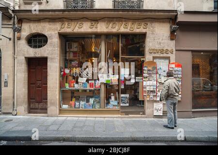 Paris book shop, view of a man looking at the front of the Librairie Ulysse book shop in the Rue Saint-Louis in central Paris, France. Stock Photo