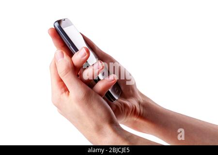 Holding a modern smartphone in both hands seen from the side, isolated on white, cut out, closeup. Two handed grip on a mobile phone, hand on hand Stock Photo