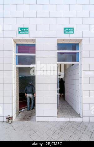 Entrance to the mosque neighboring with entrance to the toilets in Morocco, Africa Stock Photo