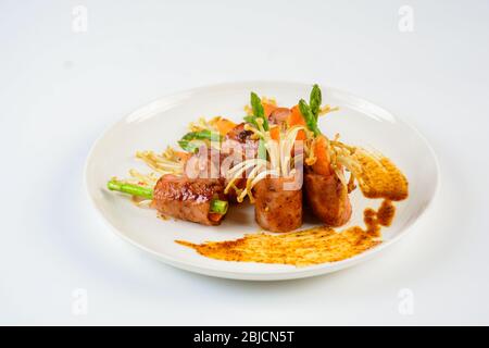 Bacon Wrapped Stuffed Mushrooms, A classic favorite stuffed mushroom is taken to new heights by wrapping in a slice of bacon. Simple, but will melt in Stock Photo