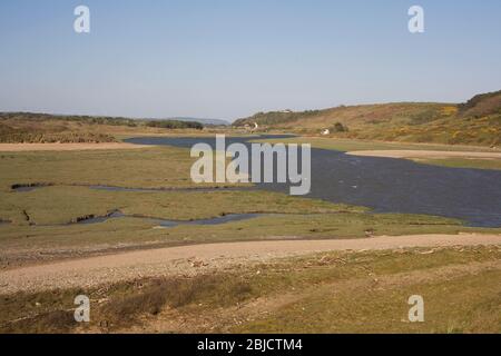 Ogmore river approaching its mouth with grassy bog late on a sunny spring afternoon Stock Photo