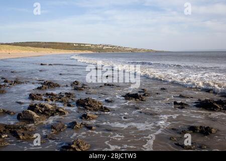 Newton beach at the end of the Black rocks looking towards Ogmore by Sea on a sunny spring evening Stock Photo