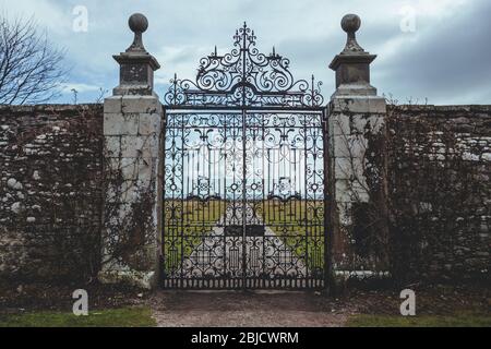 Wrought iron gate of the Dunrobin Castle in the Highland area of Scotland, looking at the Moray Firth a roughly triangular inlet of the North Sea Stock Photo