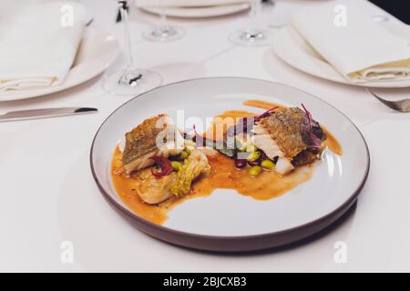 Meal of Boiled Cod Fish with black olives and green beans Stock Photo