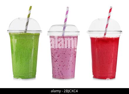 Tasty fruit cocktails in plastic cups isolated on white Stock Photo