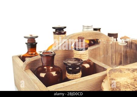 Vintage bottles in wooden box isolated on white Stock Photo