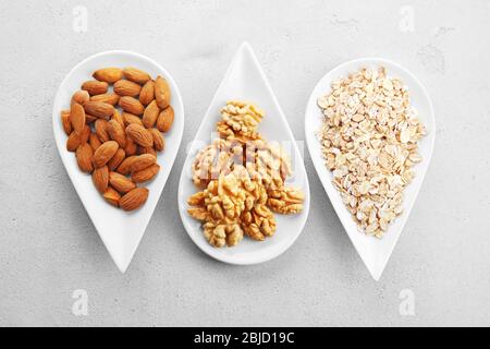 Set of diet products in saucers on grey textured background Stock Photo