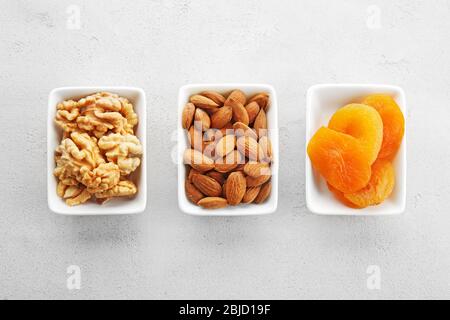 Set of diet products in saucers on grey textured background Stock Photo