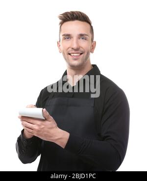 Handsome young waiter with notebook and pen on white background Stock Photo
