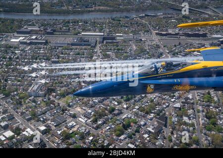 The U.S. Navy Air Demonstration Squadron, the Blue Angels, fly over parts of Philadelphia during the America Strong flyover April 28, 2020 in Philadelphia, Pennsylvania. America Strong is a salute from the Navy and Air Force to recognize healthcare workers, first responders, and other essential personnel in a show of national solidarity during the COVID-19 pandemic. Stock Photo