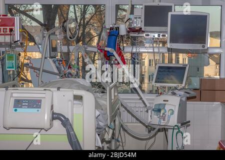 Isolation room in intensive care unit. Patient connected to medical ventilator and dialysis machine . Place where can be treated patients with pneumon Stock Photo