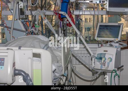 Isolation room in intensive care unit. Patient connected to medical ventilator and dialysis machine . Place where can be treated patients with pneumon Stock Photo