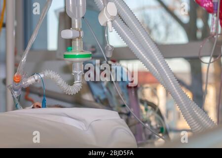 Respiratory connection tube, HME filter, carbon dioxide sensor and suction catheter, patient connected to medical ventilator in ICU in hospital. On ba Stock Photo